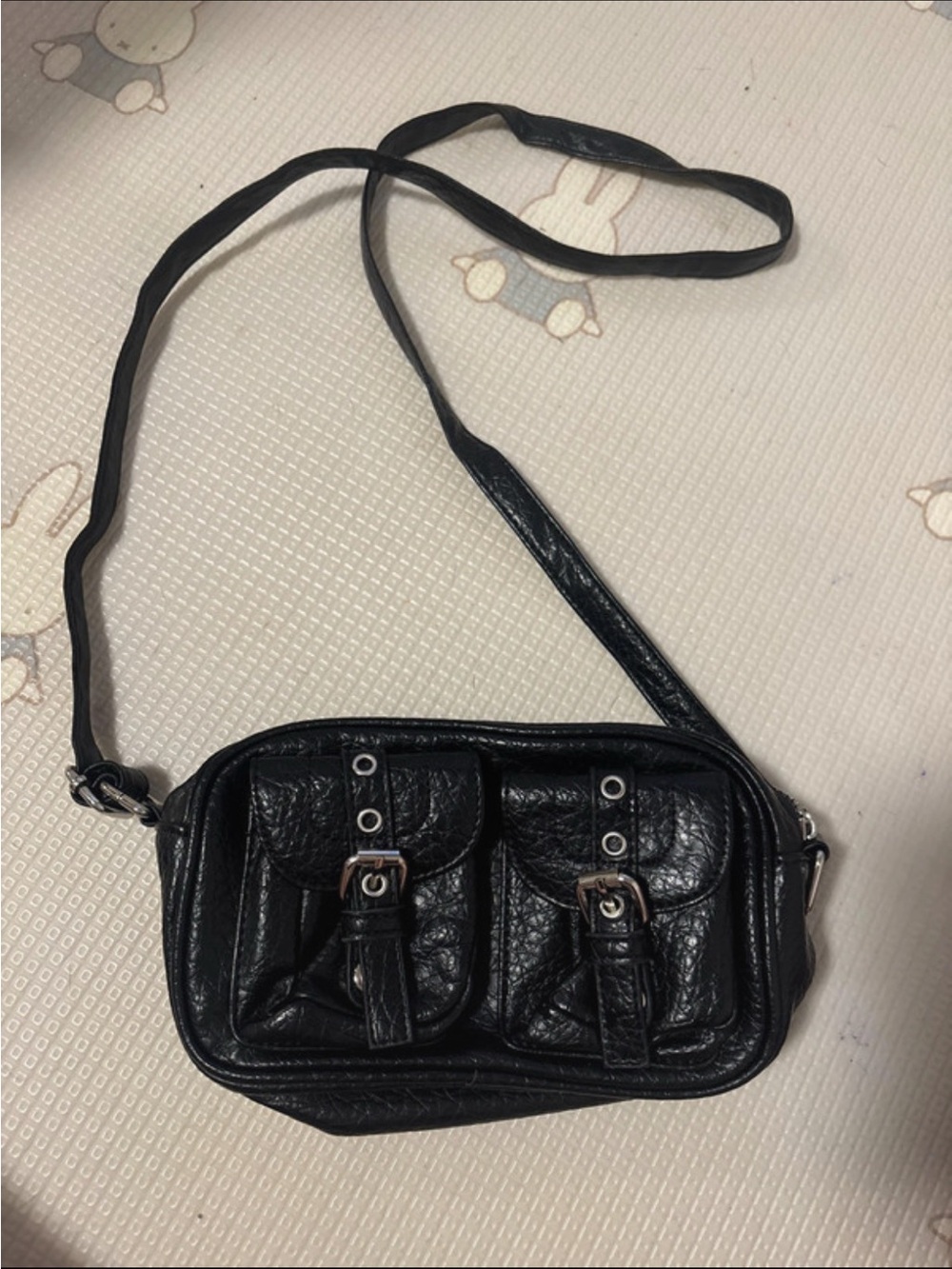 Sleek Black Faux Leather Crossbody Bag with Front Pocket Details